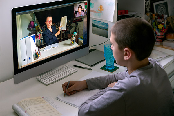 Young,Boy,Watching,Online,Class,,Live,Streaming,,Sitting,At,His